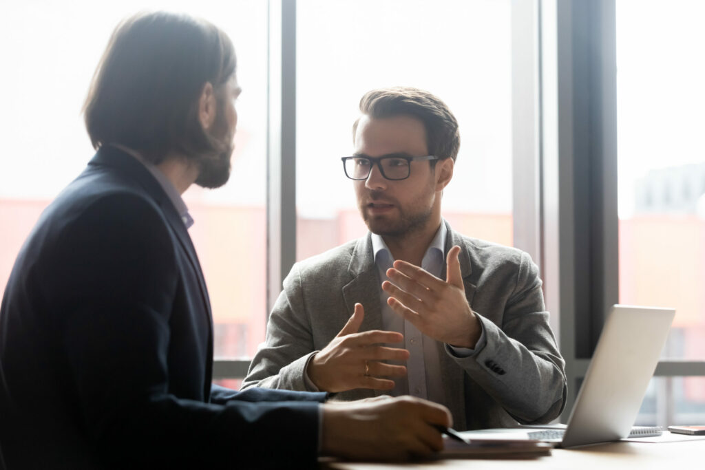 Commercial leasing lawyer discussing project with focused with clients at brainstorming meeting in office. Confident financial advisor or lawyer giving professional consultation to client