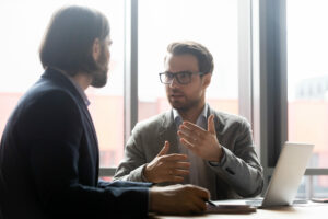 Commercial leasing lawyer discussing project with focused with clients at brainstorming meeting in office. Confident financial advisor or lawyer giving professional consultation to client