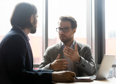 Commercial leasing lawyer discussing project with focused with clients at brainstorming meeting in office. Confident financial advisor or lawyer giving professional consultation to client